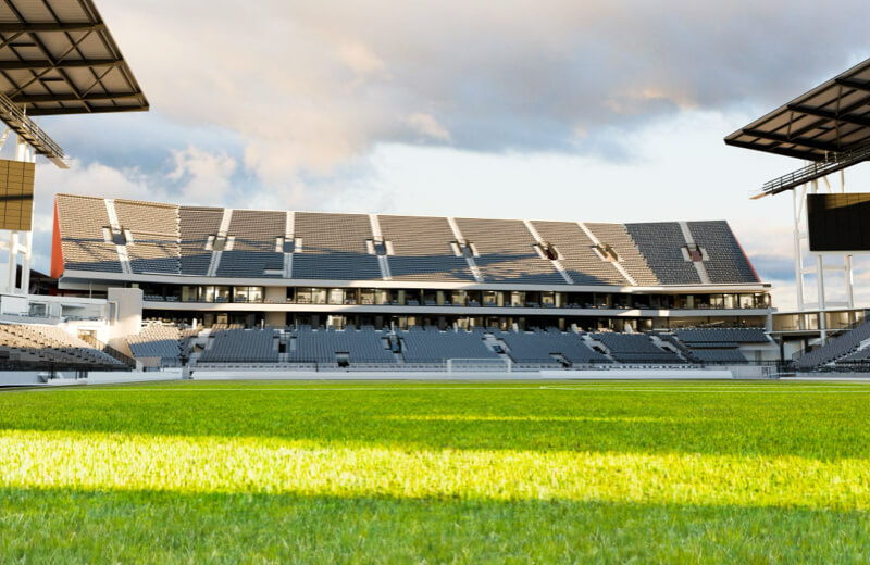 Rendering of North End and Patio from pitch of Toronto Stadium at Exhibition Place with green grass under a cloudy sky